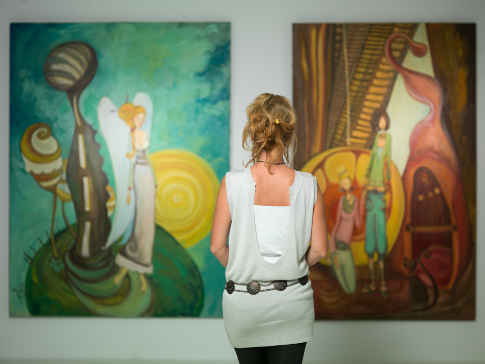 Woman gazing at art on wall
